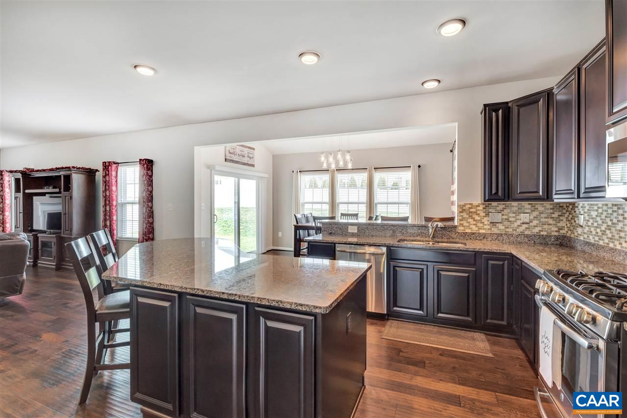365 Ridgemont Road Ruckersville, VA 22968 - Photo 5 of 50 a kitchen with granite countertop a sink stove and refrigerator