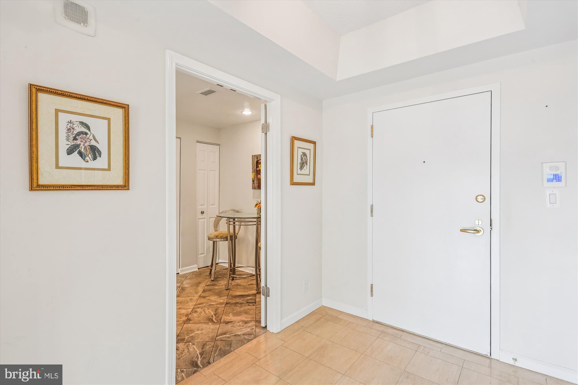 5600 Wisconsin Avenue, Unit 1105 Chevy Chase, MD 20815 - Photo 14 of 67 a view of a hallway with wooden floor and a living room