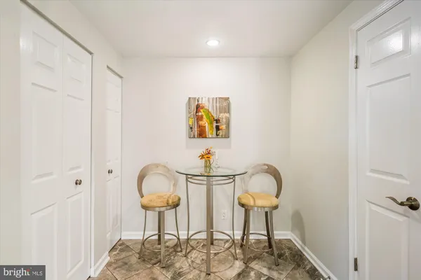 a kitchen with granite countertop white cabinets and white stainless steel appliances