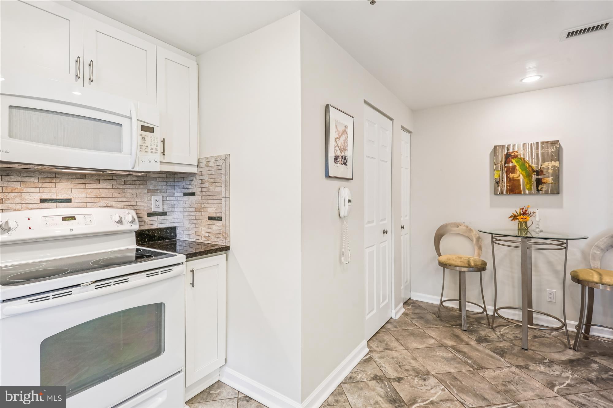 5600 Wisconsin Avenue, Unit 1105 Chevy Chase, MD 20815 - Photo 19 of 67 a kitchen with a stove cabinets and a refrigerator
