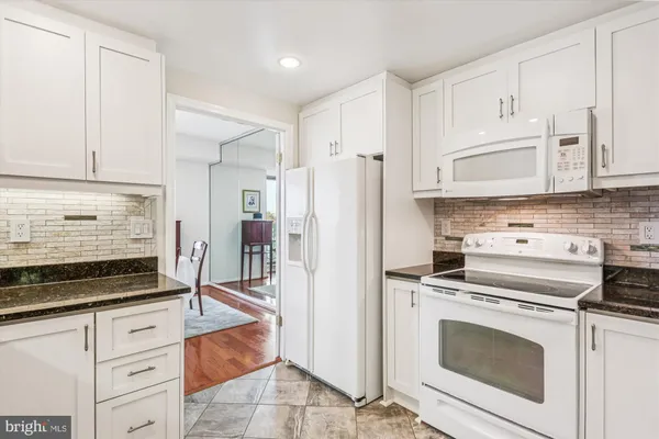 a kitchen with stainless steel appliances a sink stove and cabinets