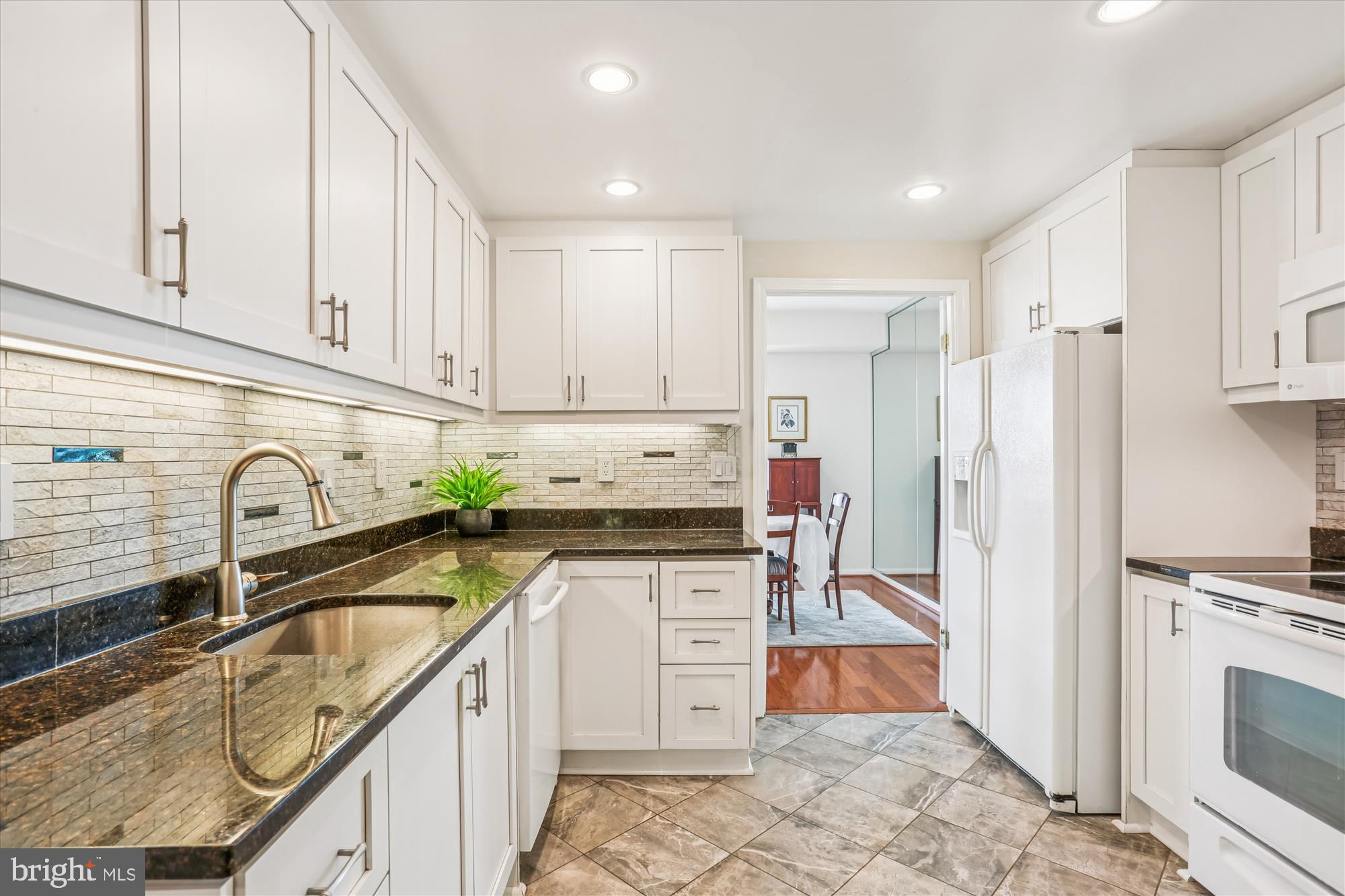 5600 Wisconsin Avenue, Unit 1105 Chevy Chase, MD 20815 - Photo 22 of 67 a kitchen with stainless steel appliances granite countertop a stove a sink and a refrigerator