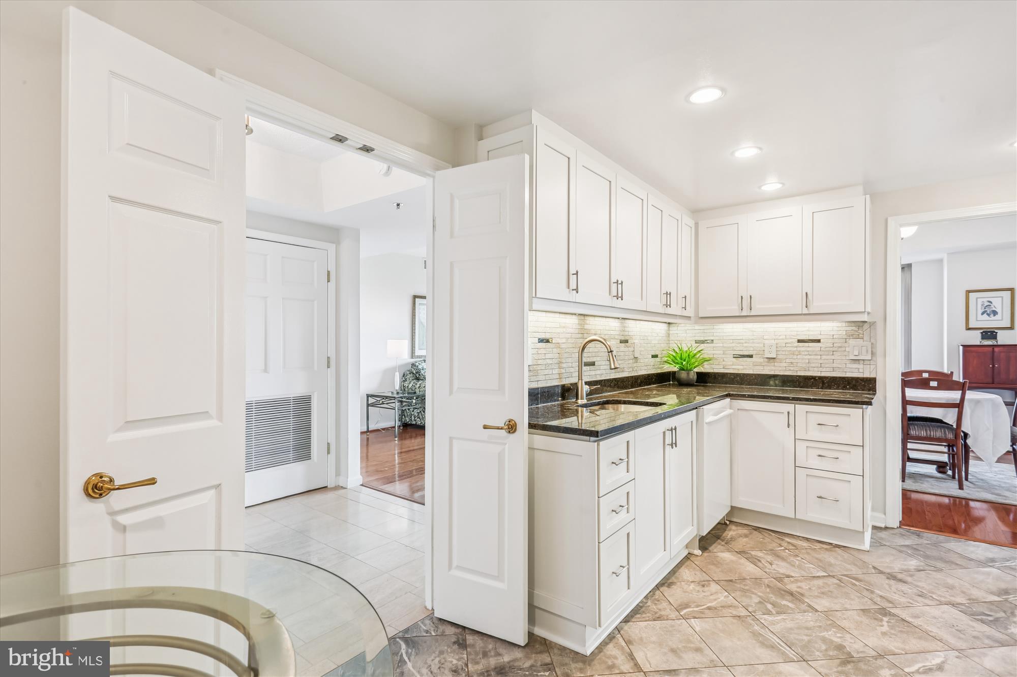 5600 Wisconsin Avenue, Unit 1105 Chevy Chase, MD 20815 - Photo 24 of 67 a kitchen with granite countertop a sink and white cabinets