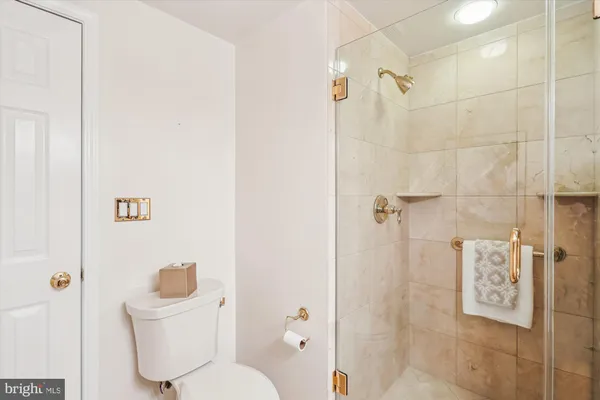 a bathroom with a tub a sink and glass door