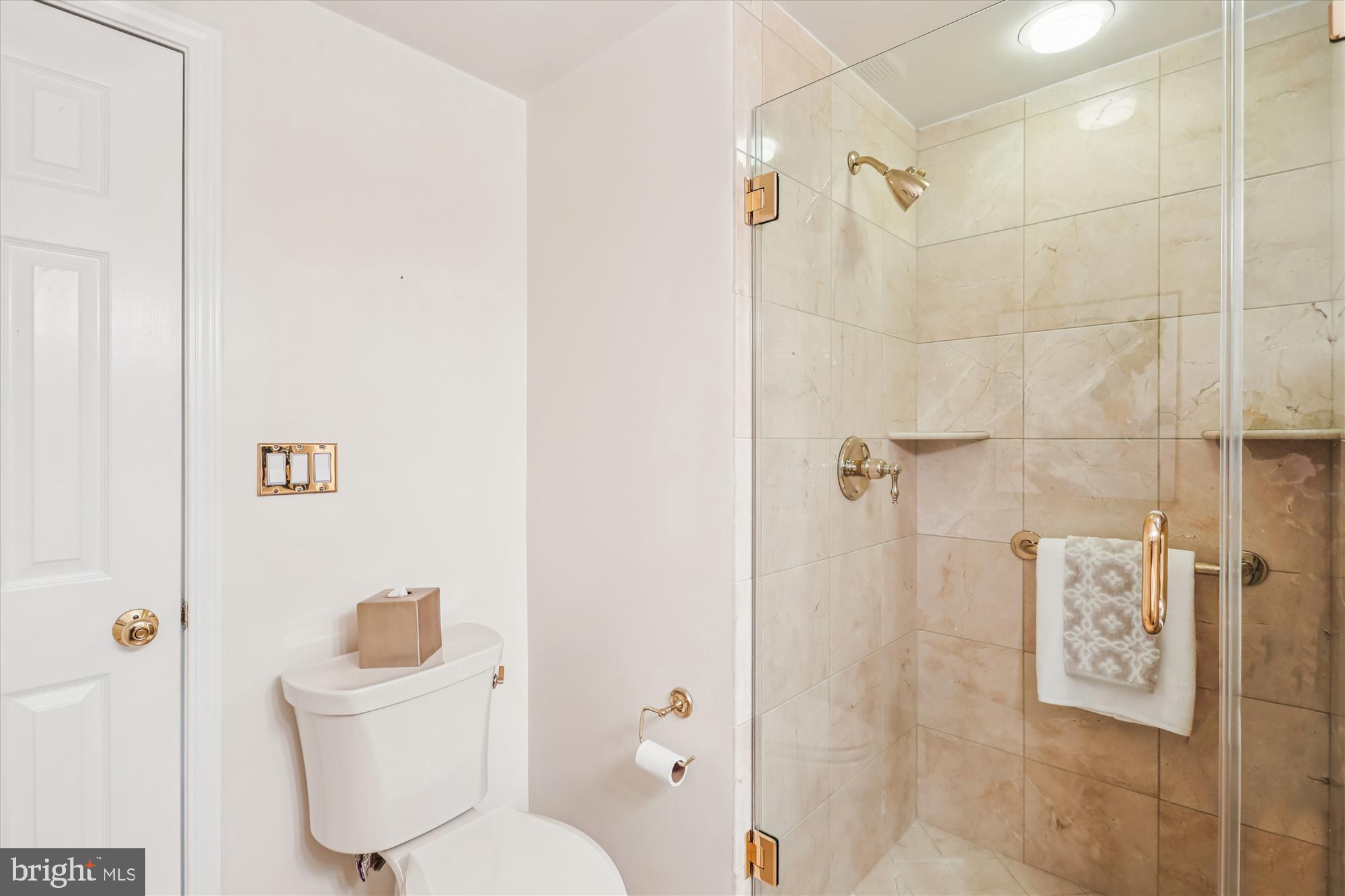 5600 Wisconsin Avenue, Unit 1105 Chevy Chase, MD 20815 - Photo 28 of 67 a white toilet sitting next to a bathroom sink
