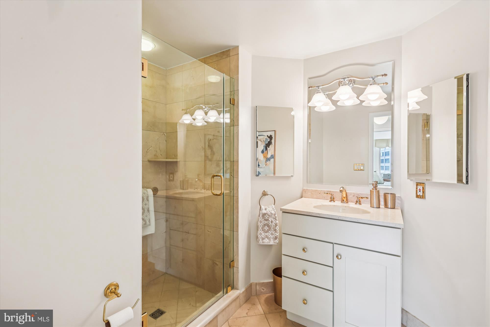 5600 Wisconsin Avenue, Unit 1105 Chevy Chase, MD 20815 - Photo 29 of 67 a bathroom with a shower sink and mirror