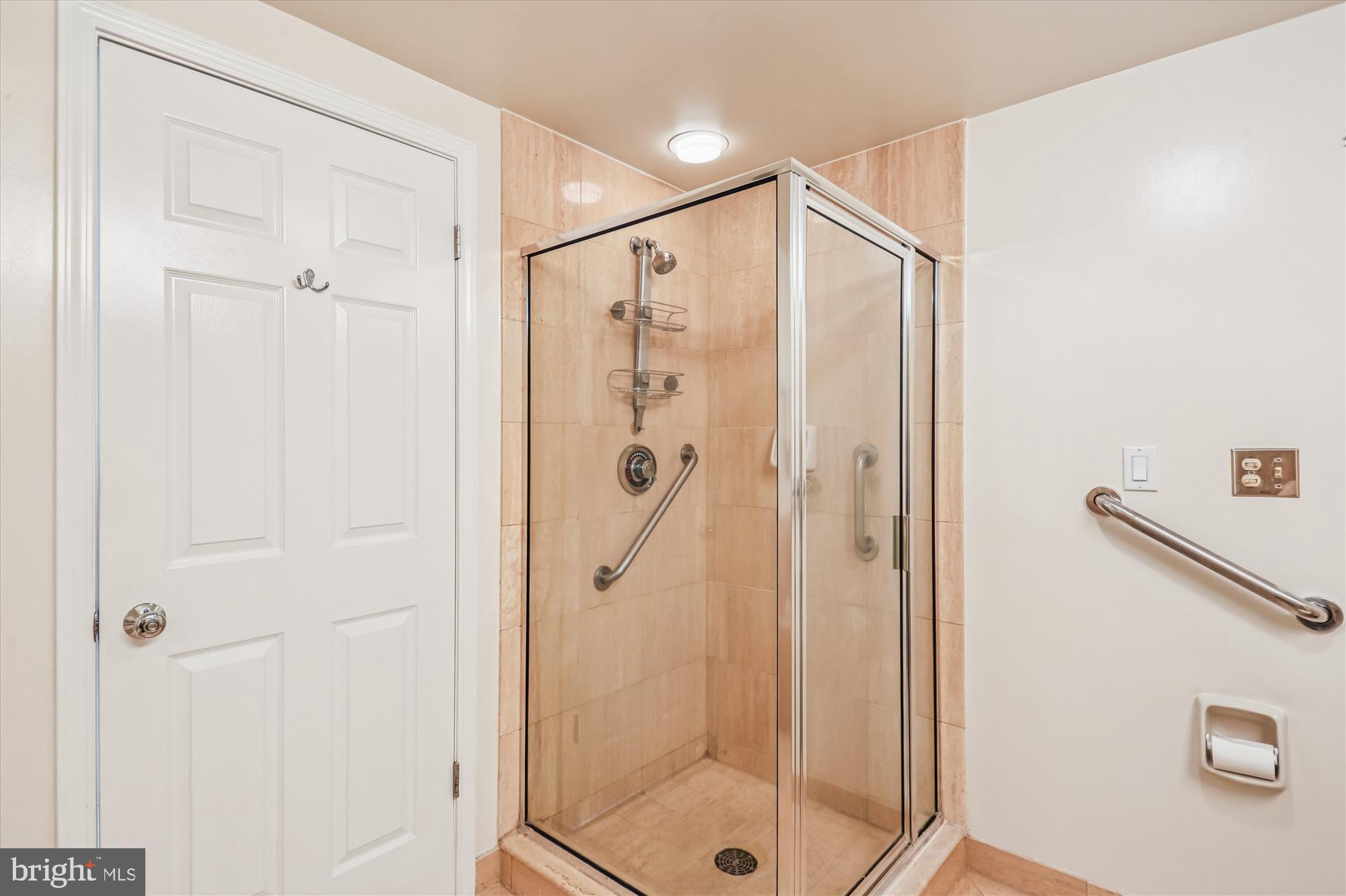5600 Wisconsin Avenue, Unit 1105 Chevy Chase, MD 20815 - Photo 31 of 67 a bathroom with a shower and a glass door