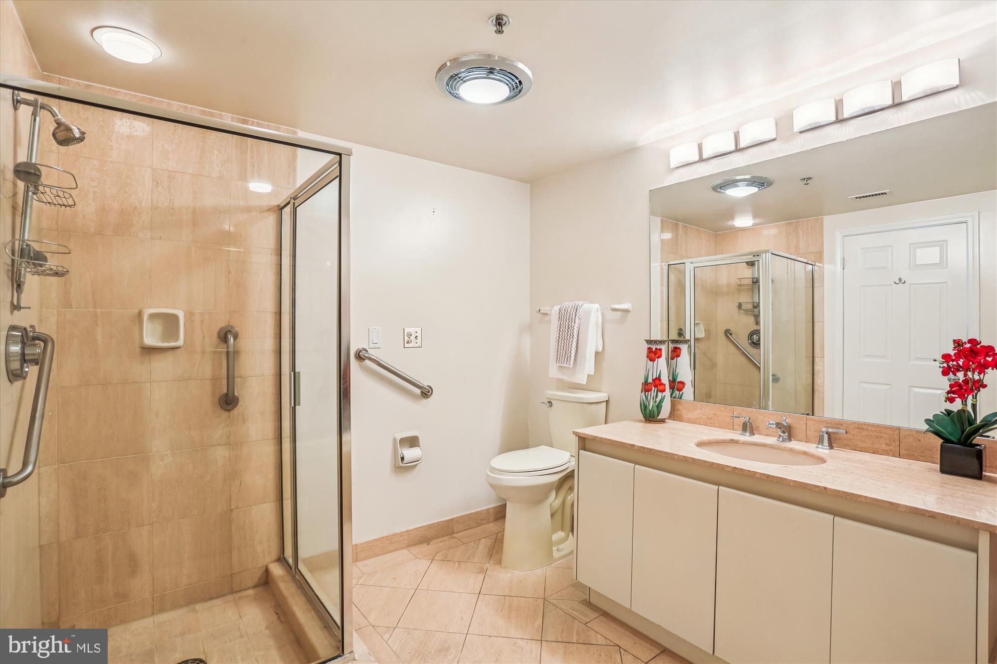 5600 Wisconsin Avenue, Unit 1105 Chevy Chase, MD 20815 - Photo 33 of 67 a bathroom with a double vanity sink toilet and shower
