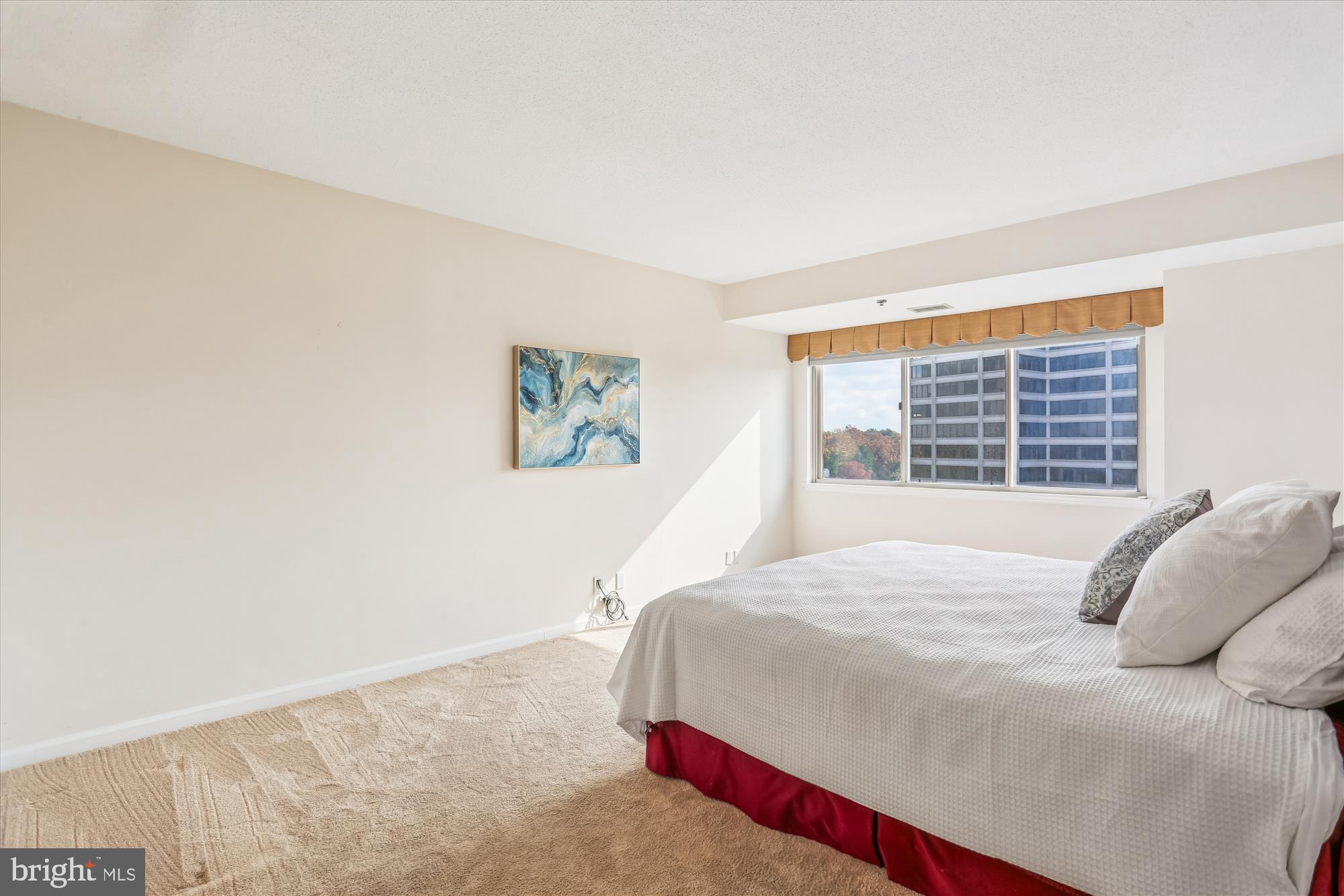 5600 Wisconsin Avenue, Unit 1105 Chevy Chase, MD 20815 - Photo 34 of 67 a bedroom with a bed and a window