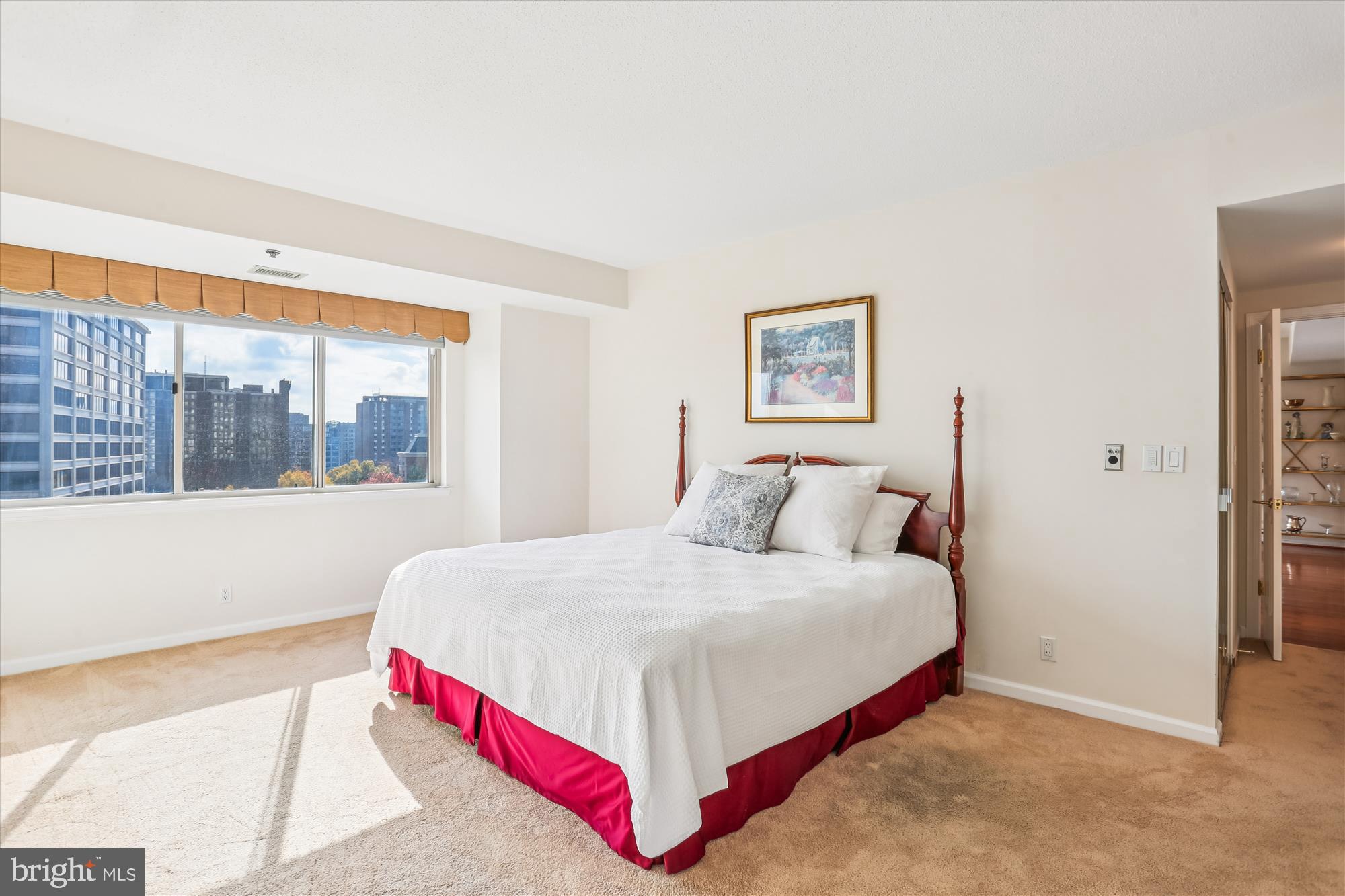 5600 Wisconsin Avenue, Unit 1105 Chevy Chase, MD 20815 - Photo 35 of 67 a bedroom with a large bed and a large window