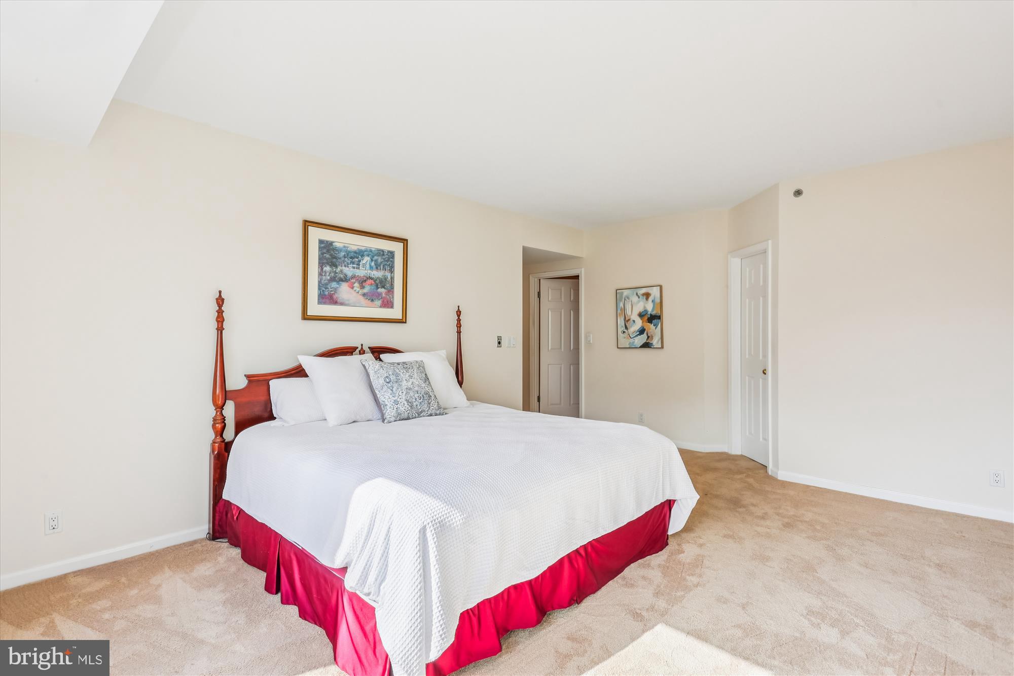 5600 Wisconsin Avenue, Unit 1105 Chevy Chase, MD 20815 - Photo 36 of 67 a bedroom with a bed and a painting on the wall