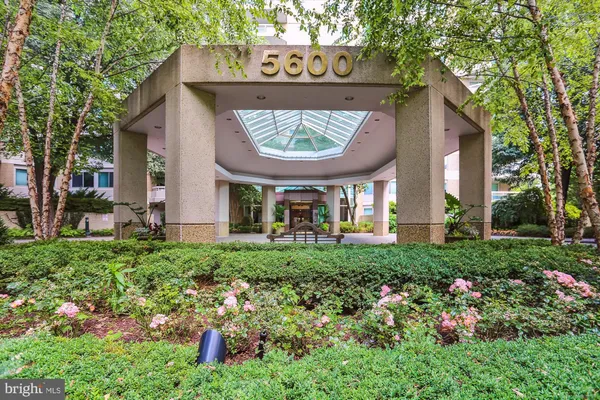 a view of a patio with a table and chairs under an umbrella