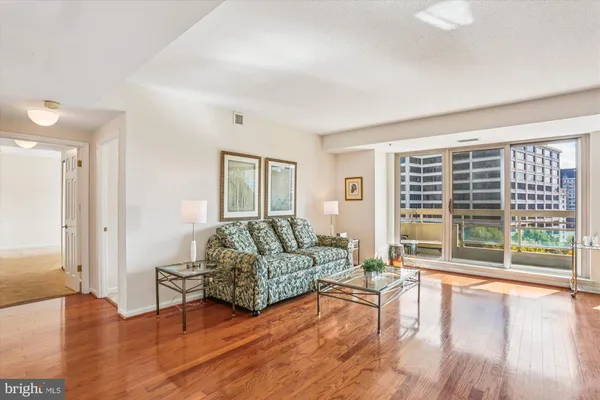 a living room with furniture and a floor to ceiling window