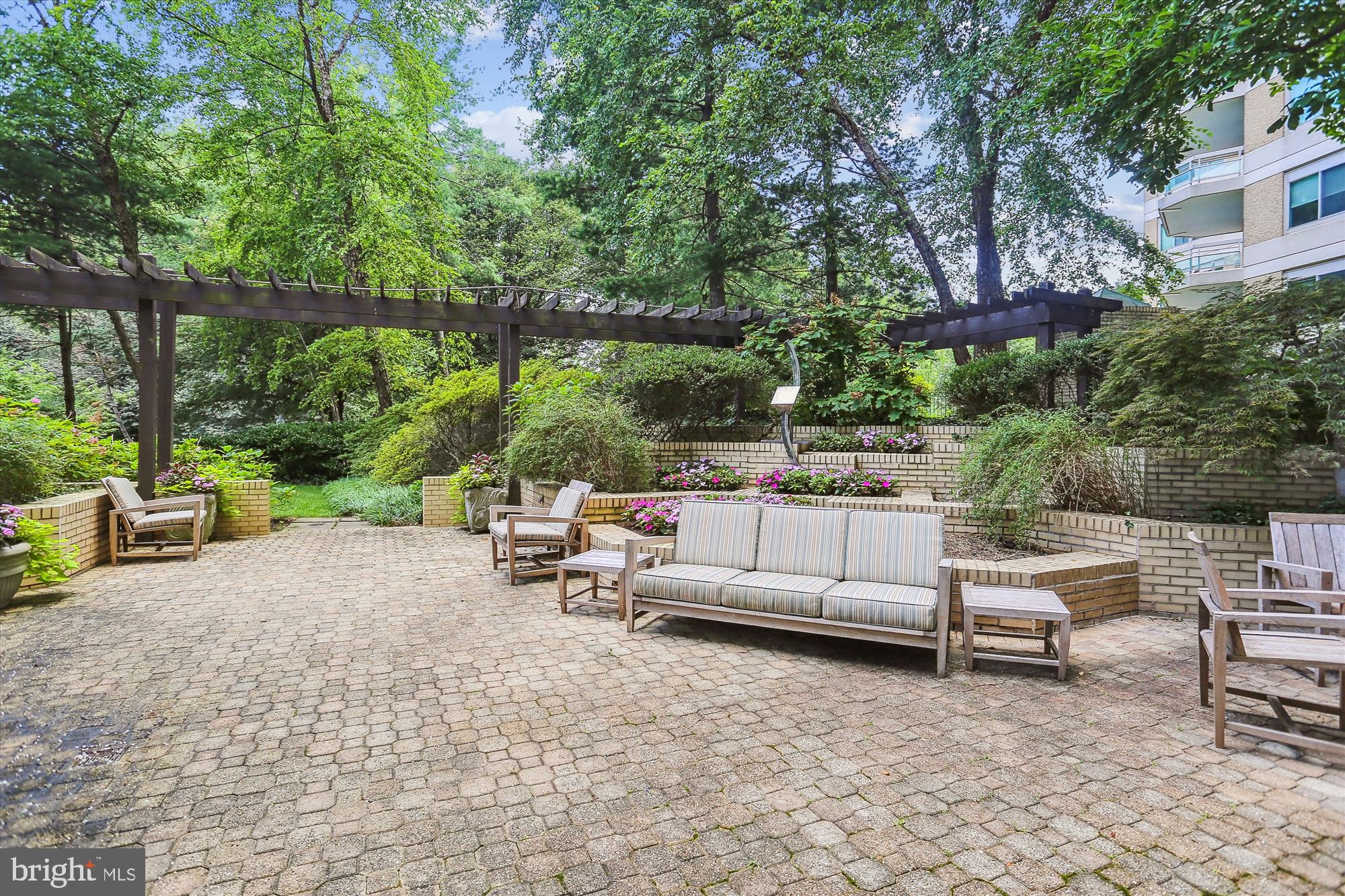 5600 Wisconsin Avenue, Unit 1105 Chevy Chase, MD 20815 - Photo 55 of 67 a view of a patio with couches and chairs under an umbrella