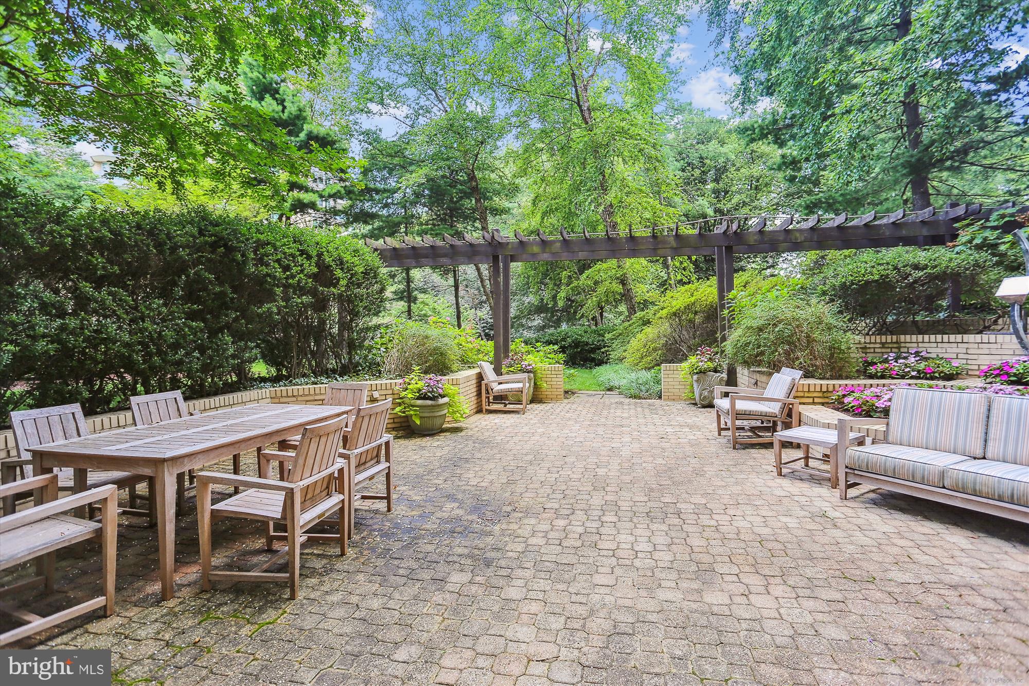 5600 Wisconsin Avenue, Unit 1105 Chevy Chase, MD 20815 - Photo 56 of 67 a view of a patio with a table and chairs under an umbrella