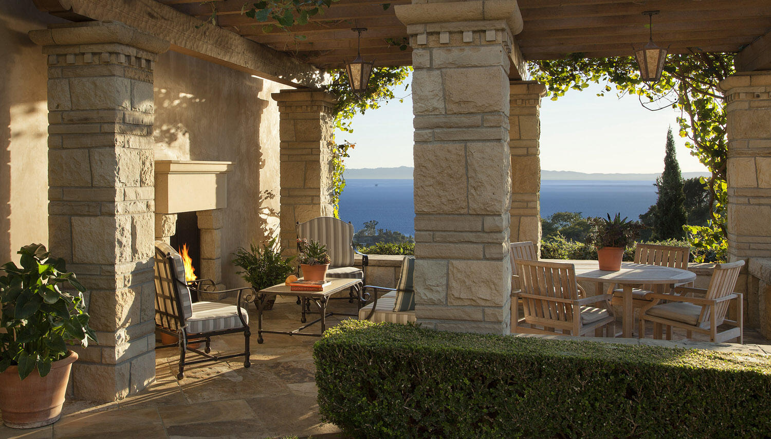550 Freehaven Drive Montecito, CA 93108 - Photo 15 of 38 a view of a patio with table and chairs potted plants