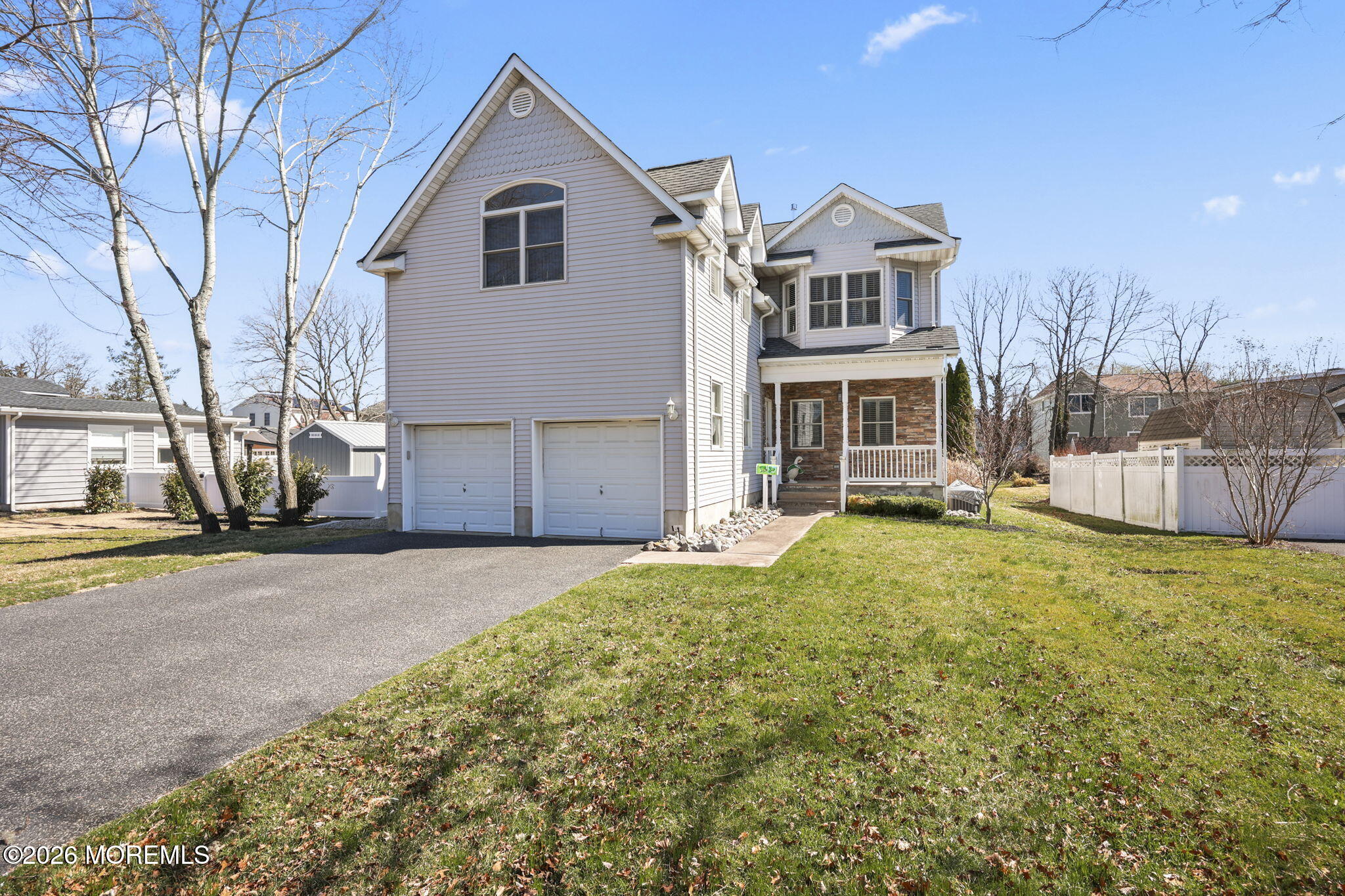 1726 M Street Wall, NJ 07719 - Photo 1 of 49 a front view of a house with a yard and garage