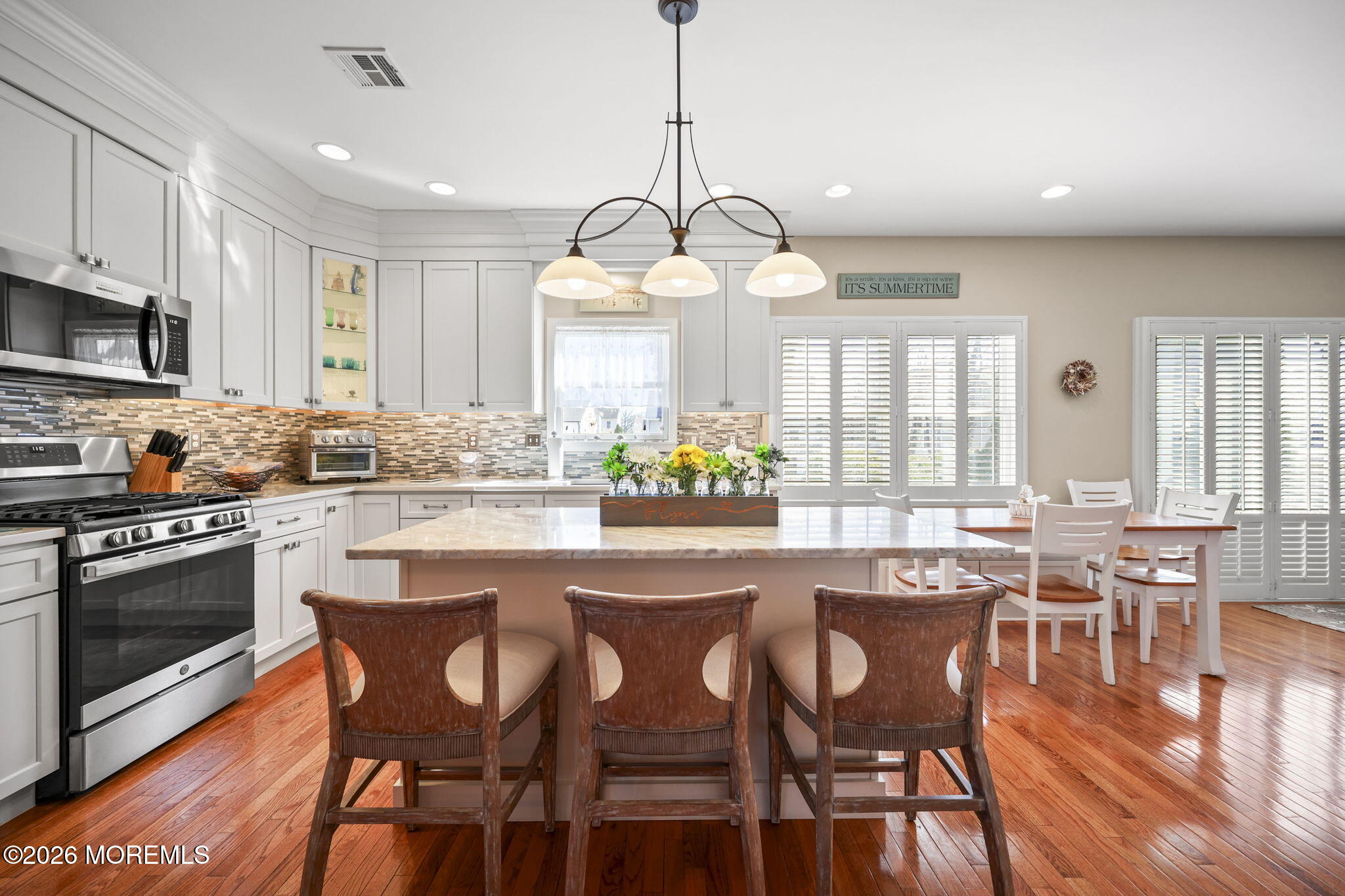 1726 M Street Wall, NJ 07719 - Photo 14 of 49 a kitchen with stainless steel appliances granite countertop a stove a kitchen island a dining table and chairs