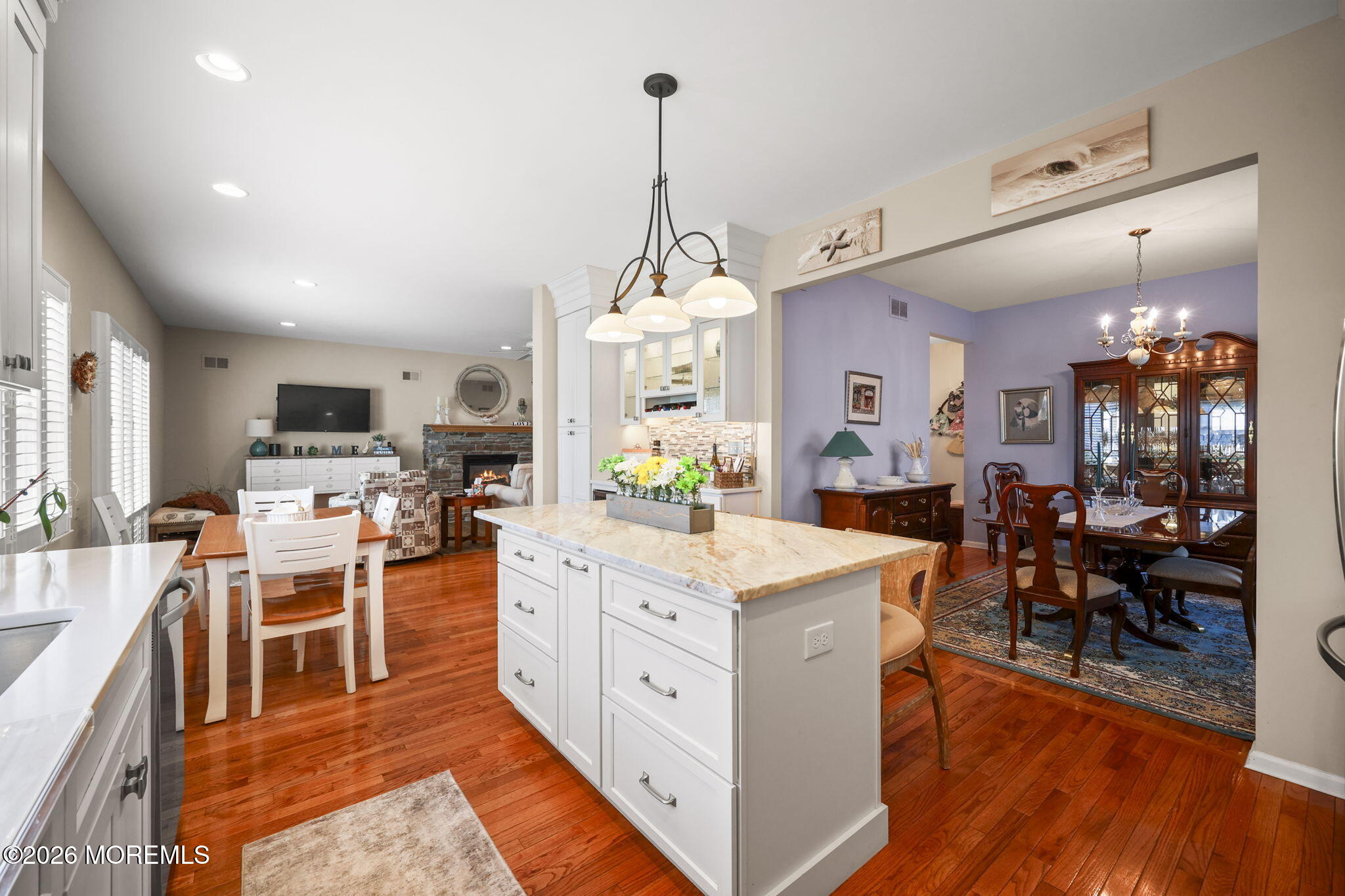 1726 M Street Wall, NJ 07719 - Photo 16 of 49 a kitchen with stainless steel appliances kitchen island granite countertop a stove a sink a refrigerator and a dining table with wooden floor