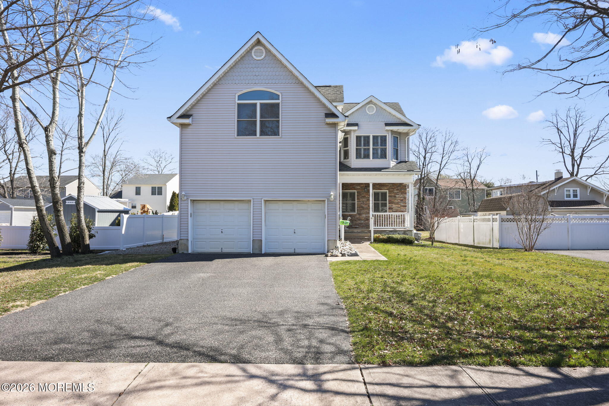 1726 M Street Wall, NJ 07719 - Photo 2 of 49 a front view of a house with a yard and garage