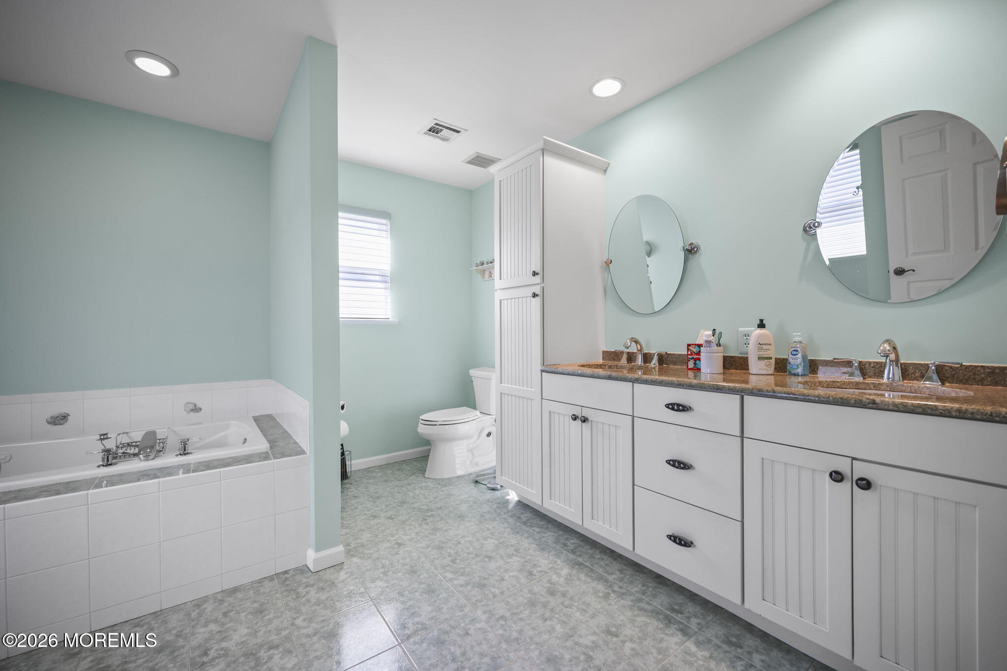 1726 M Street Wall, NJ 07719 - Photo 31 of 49 a spacious bathroom with double vanity sink a two mirror a window a bathtub and a window