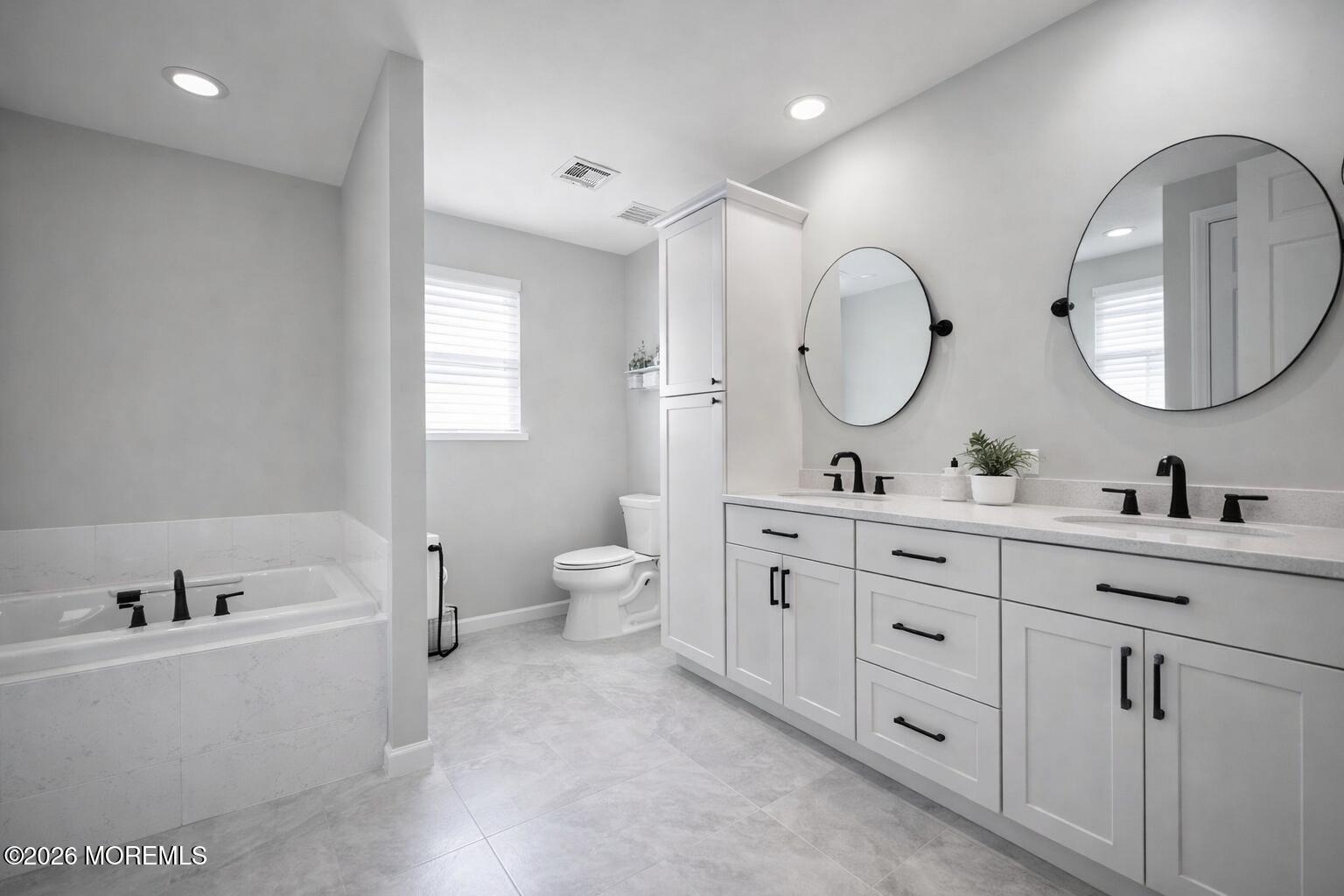 1726 M Street Wall, NJ 07719 - Photo 32 of 49 a bathroom with a double vanity sink mirror and a bathtub