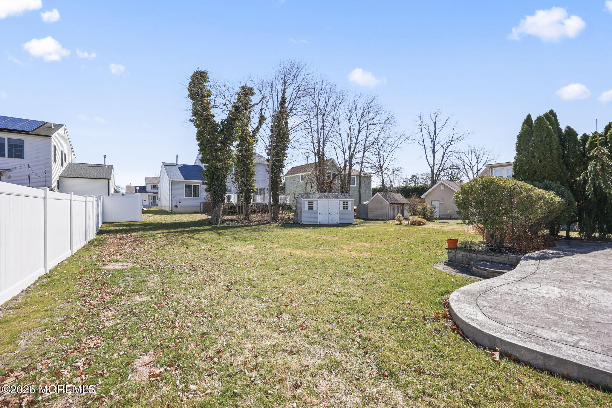 1726 M Street Wall, NJ 07719 - Photo 44 of 49 a swimming pool with yard and trees in the background