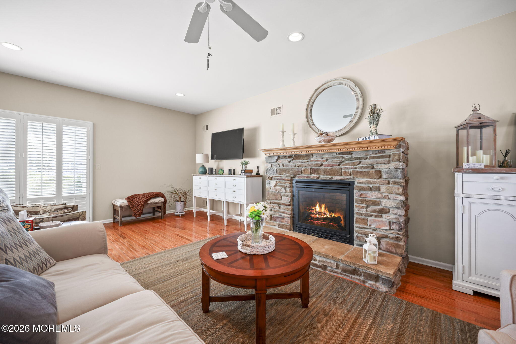 1726 M Street Wall, NJ 07719 - Photo 8 of 49 a living room with furniture a fireplace a rug and wooden floor