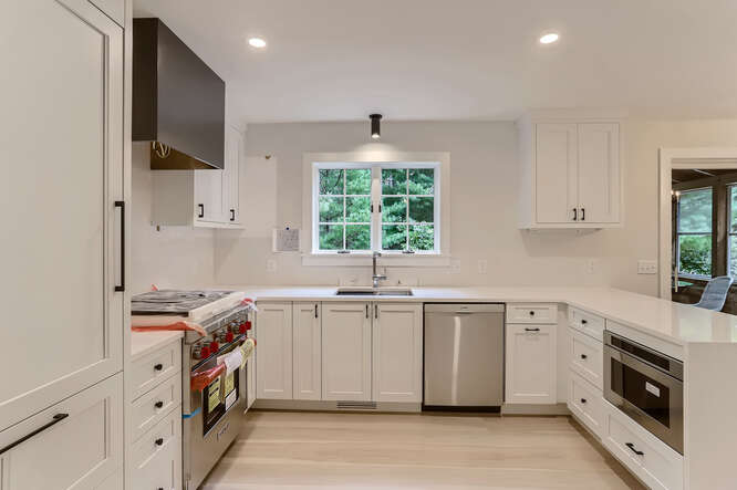 4 Penny Lane Edgartown, MA 02539 - Photo 19 of 60 a kitchen that has a sink and a stove in it