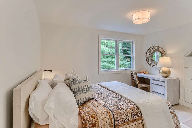 4 Penny Lane Edgartown, MA 02539 - Photo 46 of 60 a bedroom with a bed and a chandelier