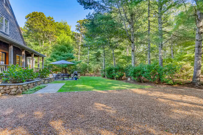 4 Penny Lane Edgartown, MA 02539 - Photo 49 of 60 a view of backyard with large trees and plants