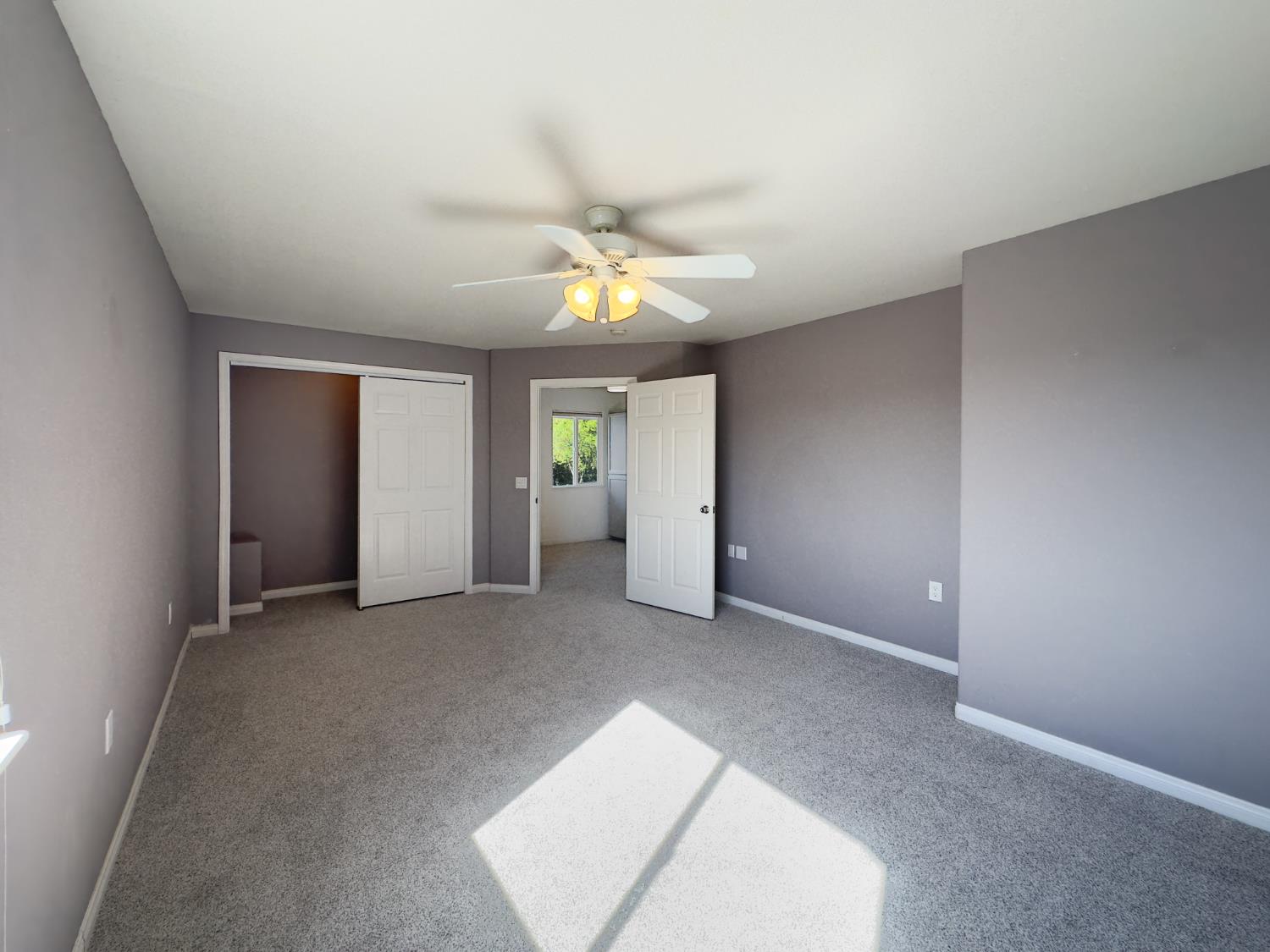 123 No Address Drive Rough and Ready, CA 95975 - Photo 16 of 95 an empty room with a chandelier fan and windows