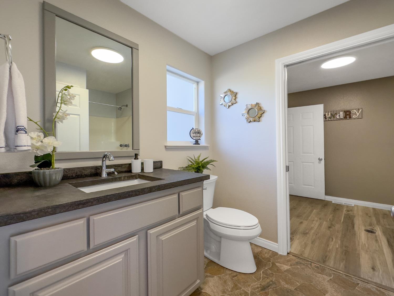 123 No Address Drive Rough and Ready, CA 95975 - Photo 44 of 95 a bathroom with a granite countertop sink a toilet and a mirror