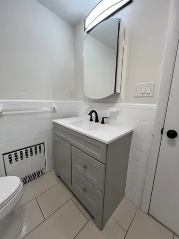a bathroom with a double vanity sink and a mirror