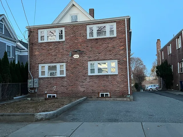 a brick building with a bench in front of it