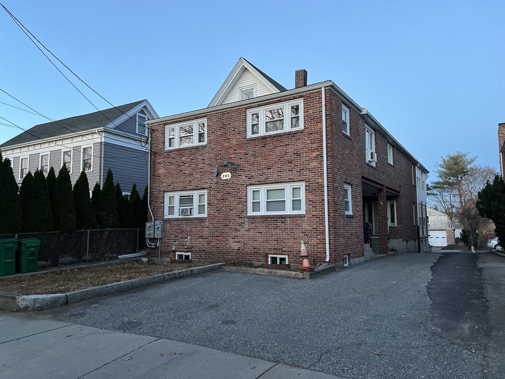 262 Nevada Street, Unit A Newton, MA 02460 - Photo 29 of 34 a front view of a house with a yard