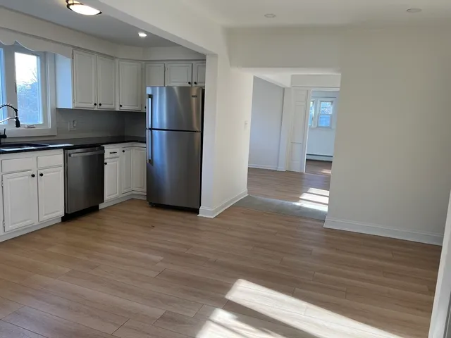 a kitchen with a refrigerator and a sink