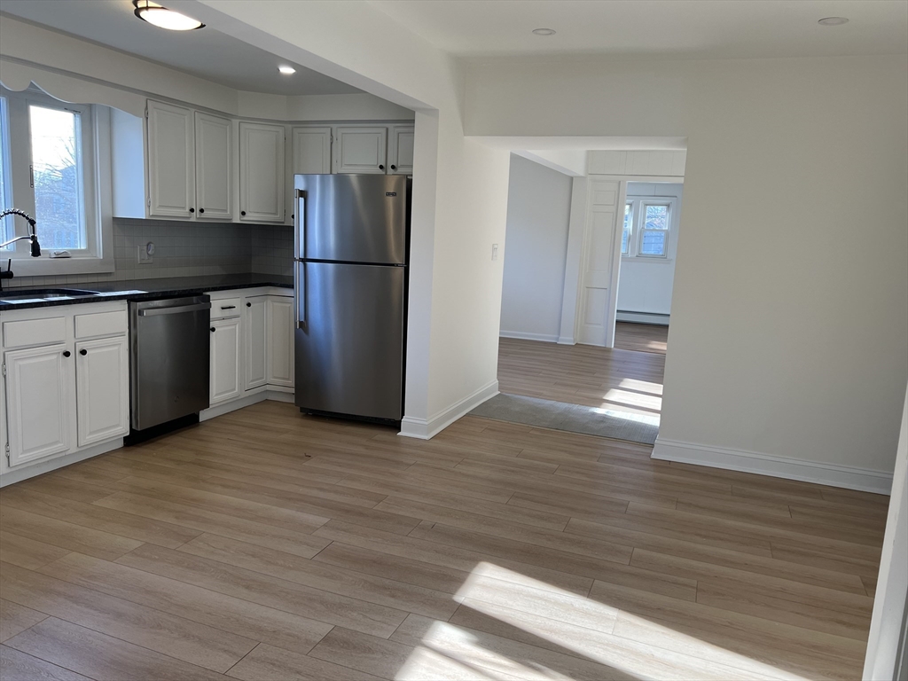 262 Nevada Street, Unit A Newton, MA 02460 - Photo 30 of 34 a kitchen with a refrigerator and a sink