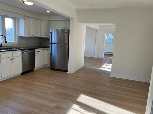 a kitchen with a refrigerator and a sink