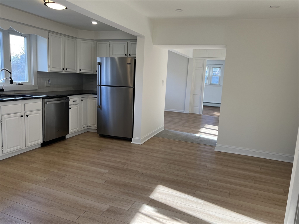262 Nevada Street, Unit A Newton, MA 02460 - Photo 31 of 34 a kitchen with a refrigerator and a sink