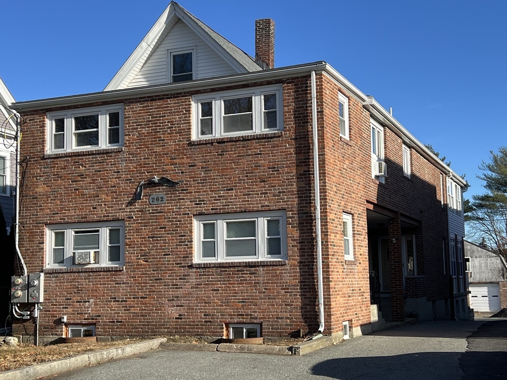 262 Nevada Street, Unit A Newton, MA 02460 - Photo 32 of 34 a front view of a house with a yard