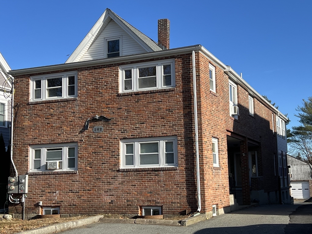 262 Nevada Street, Unit A Newton, MA 02460 - Photo 33 of 34 a front view of a house with a yard