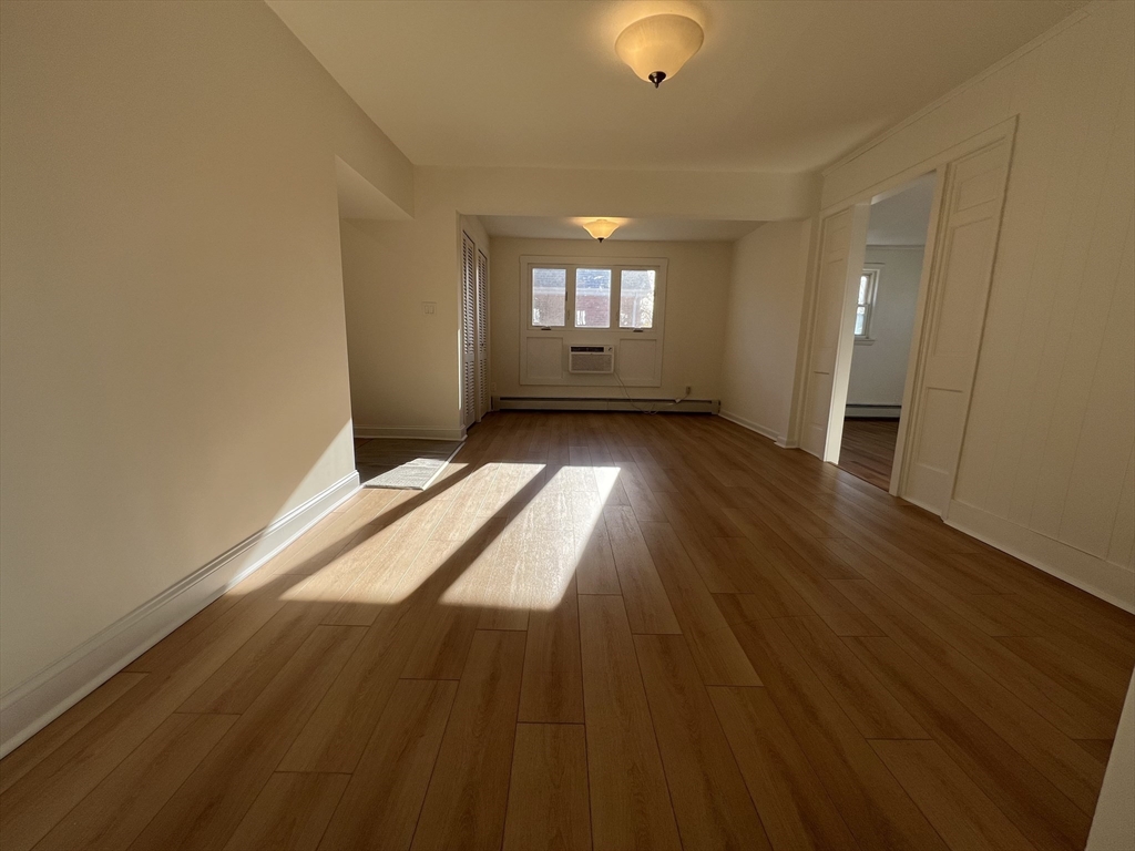 262 Nevada Street, Unit A Newton, MA 02460 - Photo 8 of 34 wooden floor in an empty room with a window