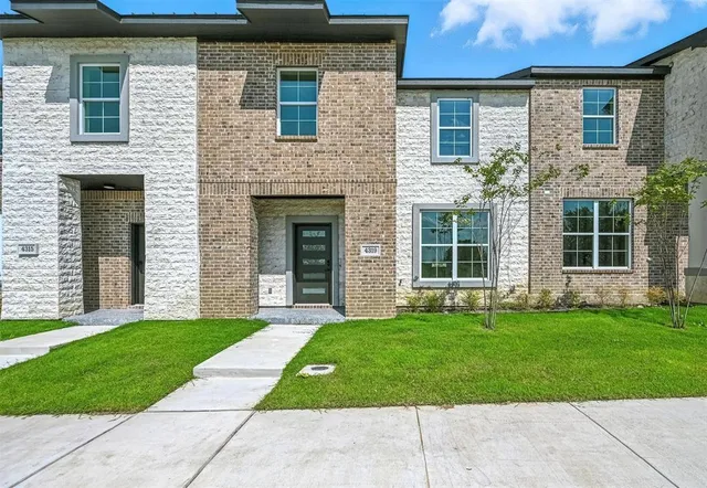 a view of a brick house with a large windows