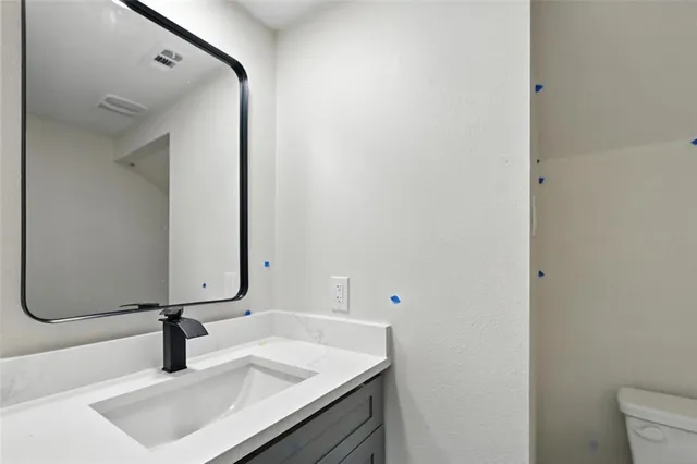 a bathroom with a sink vanity and a mirror
