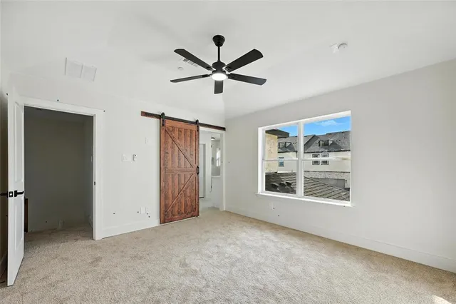 a view of a livingroom with a ceiling fan and window