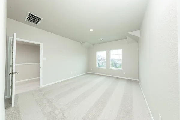 a view of an empty room and a window