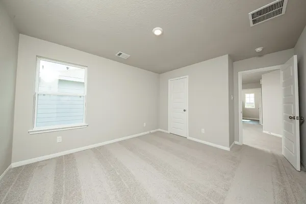 an empty room with windows and closet