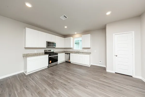 a kitchen with a white cabinets and white appliances