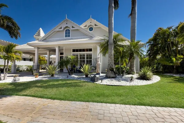 a front view of a house with a garden and plants